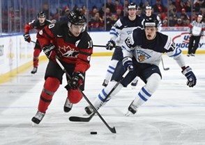BUFFALO, NEW YORK - DECEMBER 26: Canada's Kale Clague #10 skates with the puck while Finland's Otto Koivula #12 chases him down during preliminary round action at the 2018 IIHF World Junior Championship. (Photo by Matt Zambonin/HHOF-IIHF Images)

