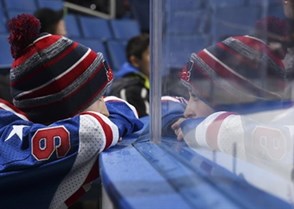 BUFFALO, NEW YORK - DECEMBER 31: A young fan looks on through the glass during Russia vs Sweden preliminary round action at the 2018 IIHF World Junior Championship. (Photo by Matt Zambonin/HHOF-IIHF Images)

